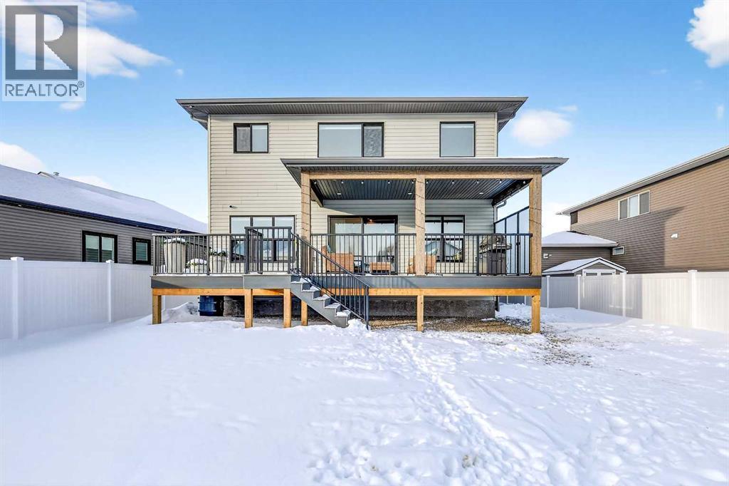 Asphalt Shingles / Prolock Metal Accent Roofs - 24 Napoleon Meadows Way, Innisfail, AB - Outdoor With Deck Patio Veranda