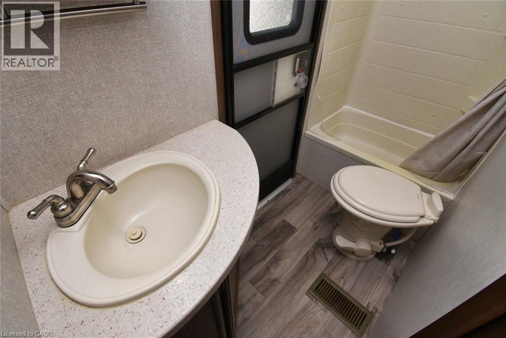 Bathroom featuring vanity and dark wood-type flooring - 1085 10Th Concession Road W Unit# 29, Flamborough, ON - Indoor Photo Showing Bathroom