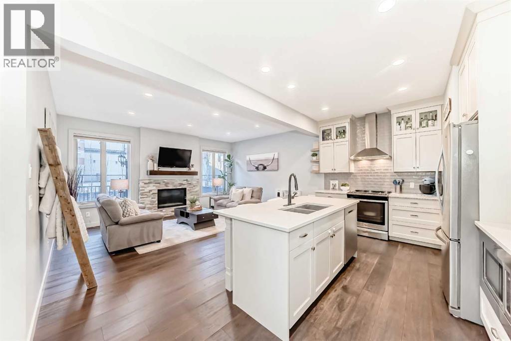 743 Shawnee Drive Sw, Calgary, AB - Indoor Photo Showing Kitchen With Fireplace With Double Sink With Upgraded Kitchen