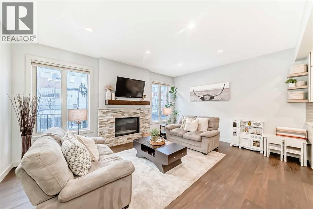 743 Shawnee Drive Sw, Calgary, AB - Indoor Photo Showing Living Room With Fireplace