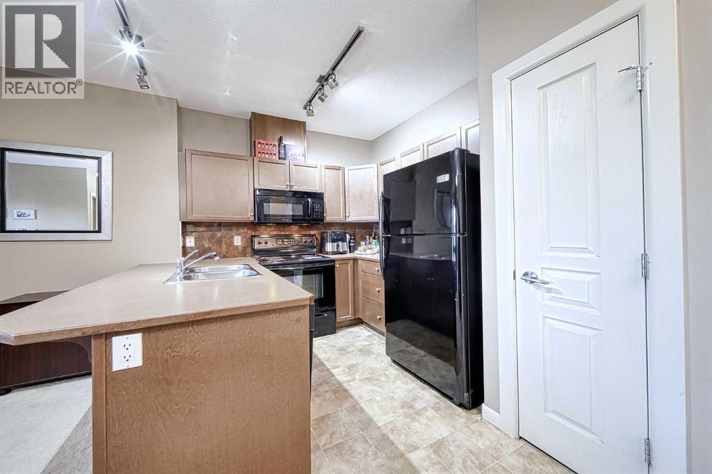 242, 52 Cranfield Link Se, Calgary, AB - Indoor Photo Showing Kitchen With Double Sink