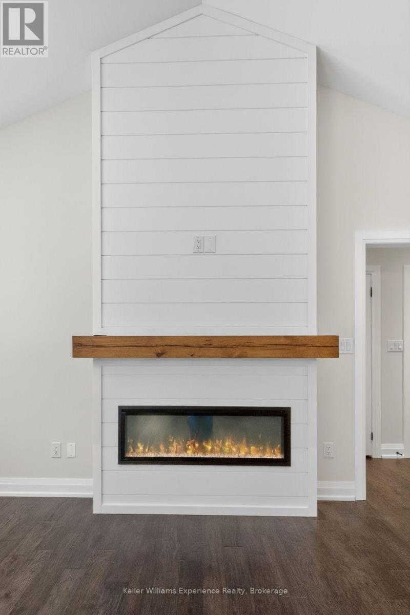 62 Rue Vanier, Tiny, ON - Indoor Photo Showing Living Room With Fireplace