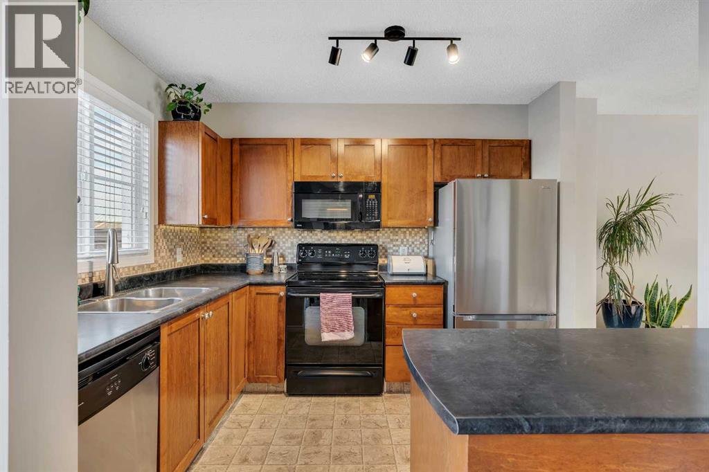 86 Eversyde Common Sw, Calgary, AB - Indoor Photo Showing Kitchen With Double Sink