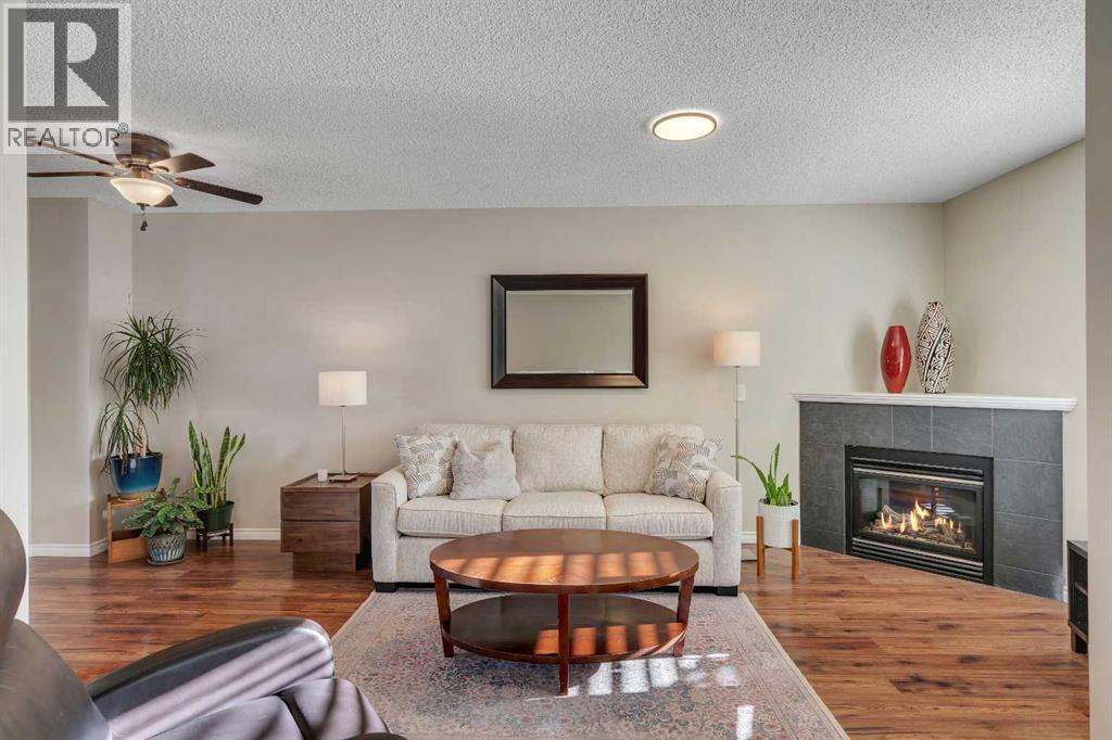 86 Eversyde Common Sw, Calgary, AB - Indoor Photo Showing Living Room With Fireplace