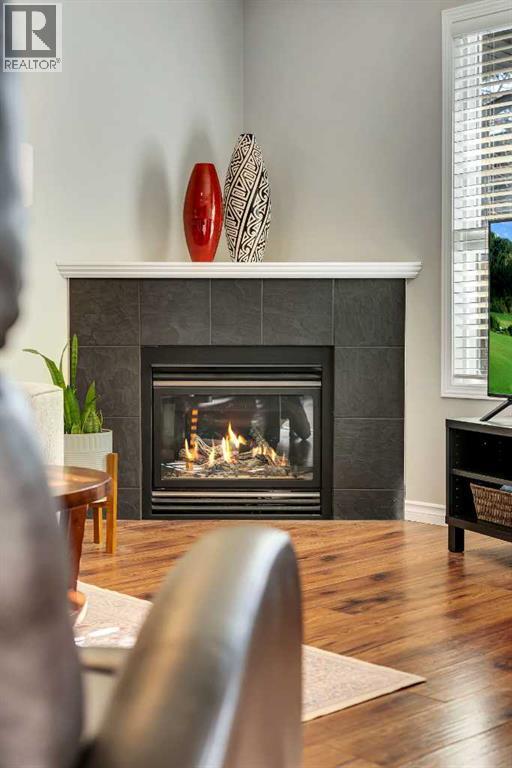 86 Eversyde Common Sw, Calgary, AB - Indoor Photo Showing Living Room With Fireplace
