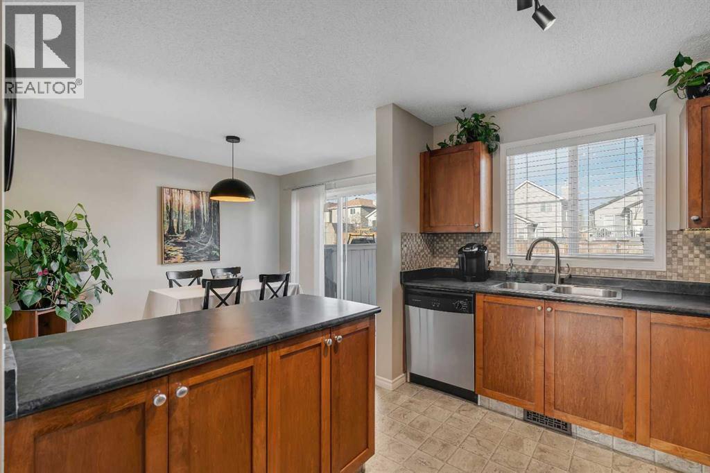 86 Eversyde Common Sw, Calgary, AB - Indoor Photo Showing Kitchen With Double Sink
