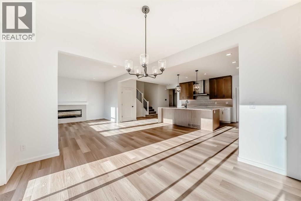 PLEASE NOTE: Kitchen appliances are included, and will be installed prior to possession - 63 Creekside Path Sw, Calgary, AB - Indoor With Fireplace