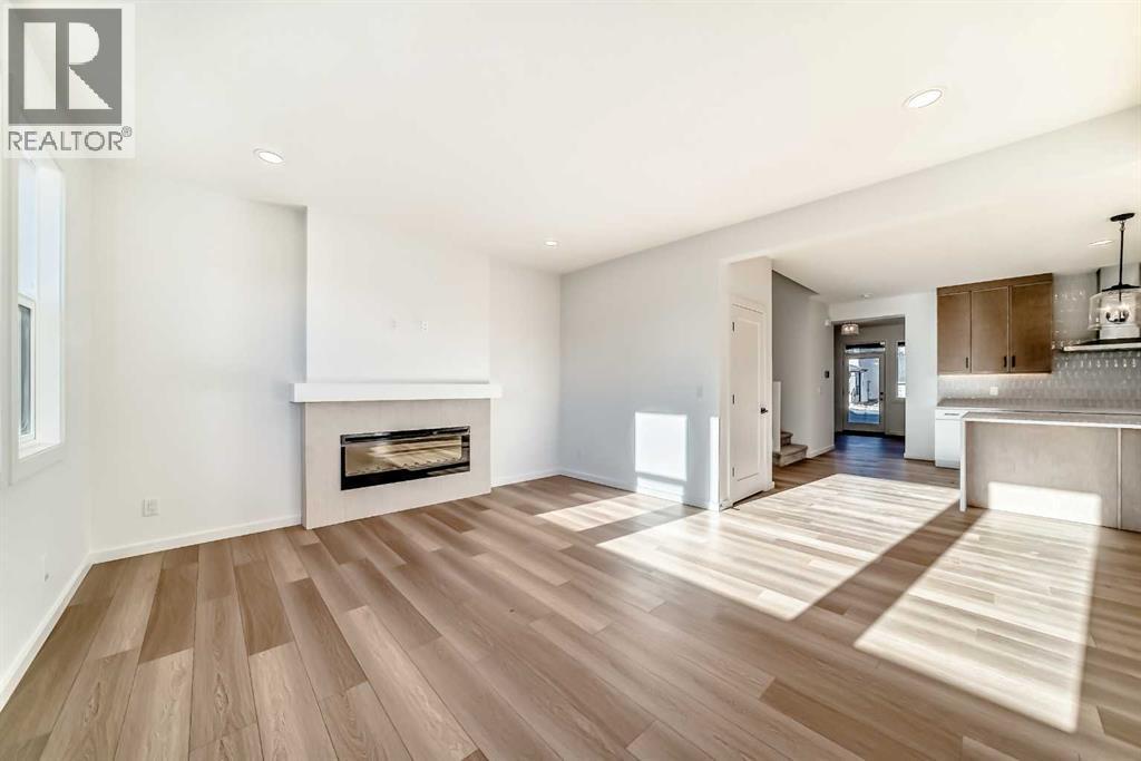 63 Creekside Path Sw, Calgary, AB - Indoor Photo Showing Living Room With Fireplace