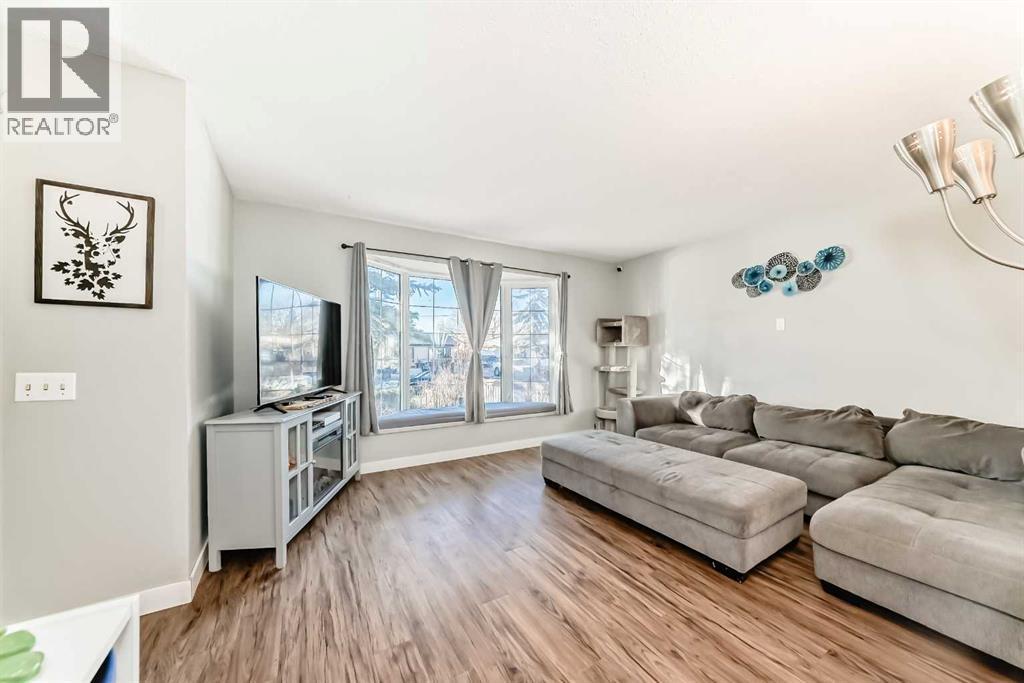 This home has been transformed by the current owner, including all brand new windows, painted throughout and more! - 7840 20A Street Se, Calgary, AB - Indoor Photo Showing Living Room