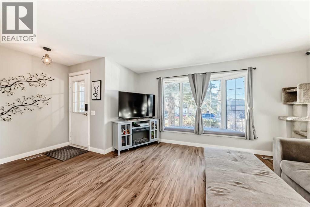 Your new bay window, with an added bench (and storage under the bench) - 7840 20A Street Se, Calgary, AB - Indoor Photo Showing Living Room