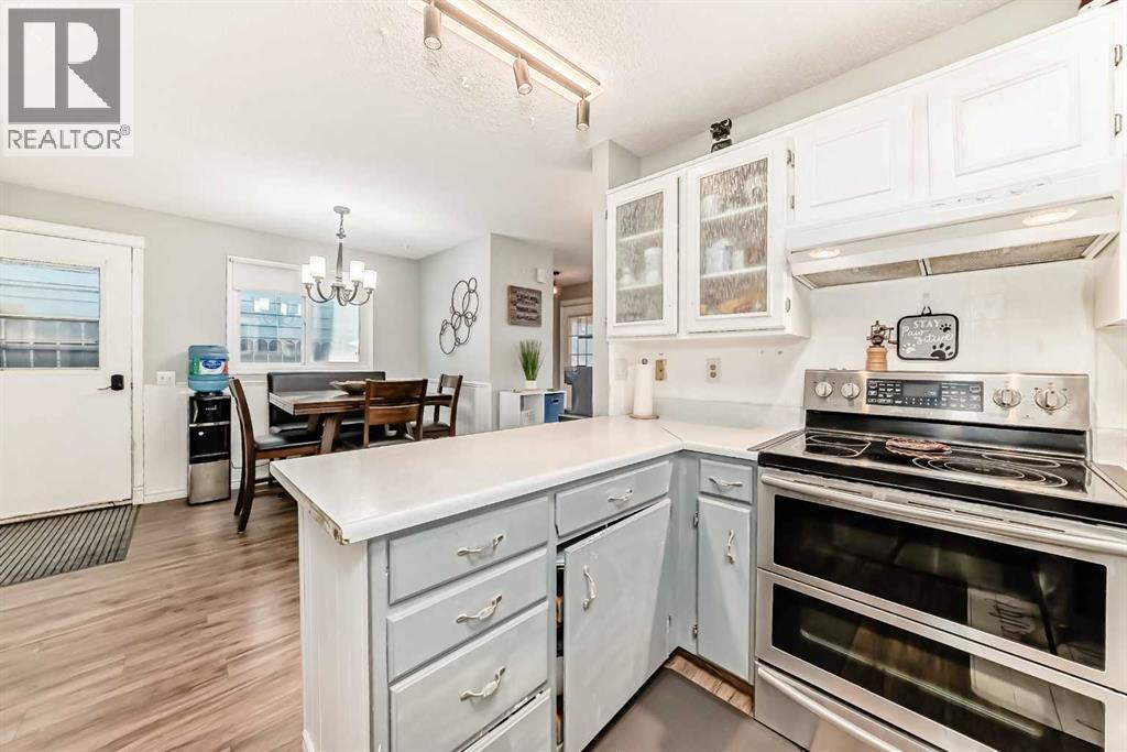 Your kitchen and dining area is the perfect place to visit, while preparing meals for friends and family - 7840 20A Street Se, Calgary, AB - Indoor Photo Showing Kitchen