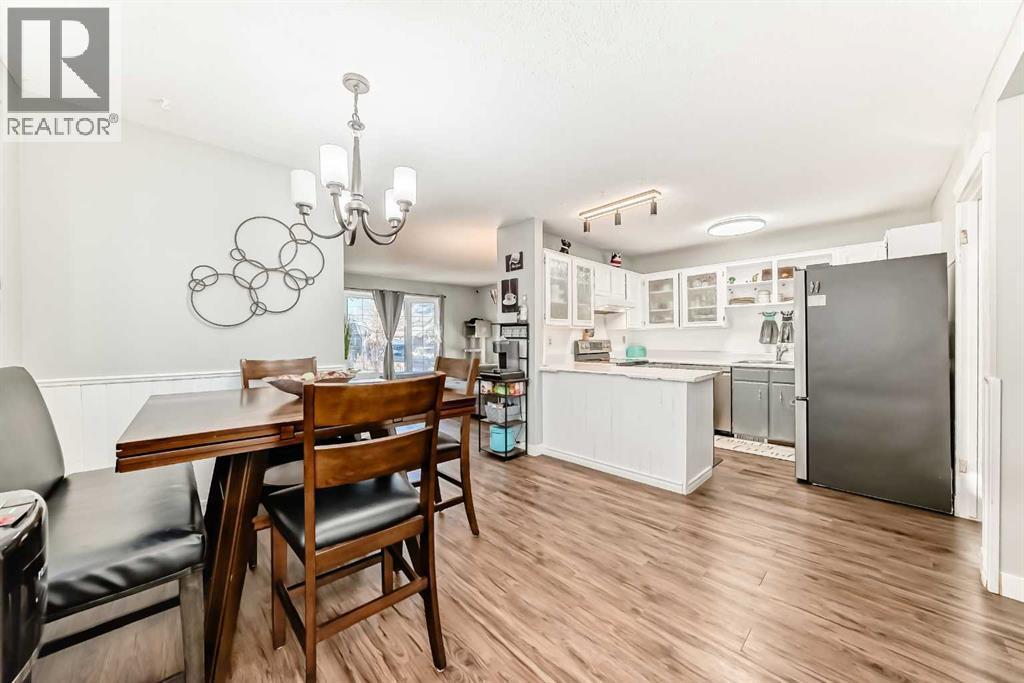 Dining and kitchen area, located just off the large livingroom - 7840 20A Street Se, Calgary, AB - Indoor Photo Showing Dining Room