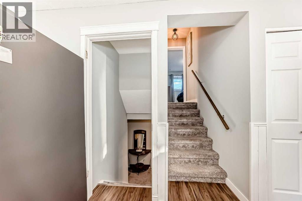 Stairs going up and down in this 3-level split - 7840 20A Street Se, Calgary, AB - Indoor Photo Showing Other Room