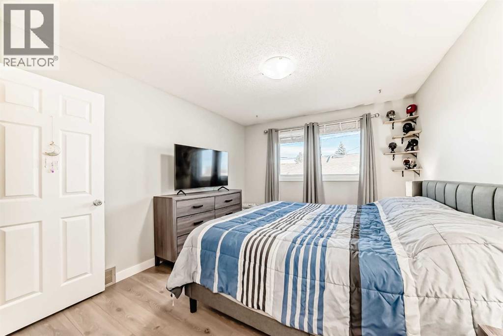 New windows, flooring and a refined space - 7840 20A Street Se, Calgary, AB - Indoor Photo Showing Bedroom