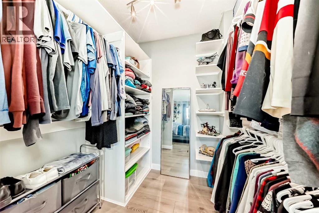 This stunning custom made closet provides plenty of space for two - 7840 20A Street Se, Calgary, AB - Indoor With Storage