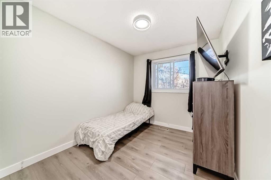Secondary bedroom, with brand new windows - 7840 20A Street Se, Calgary, AB - Indoor Photo Showing Bedroom