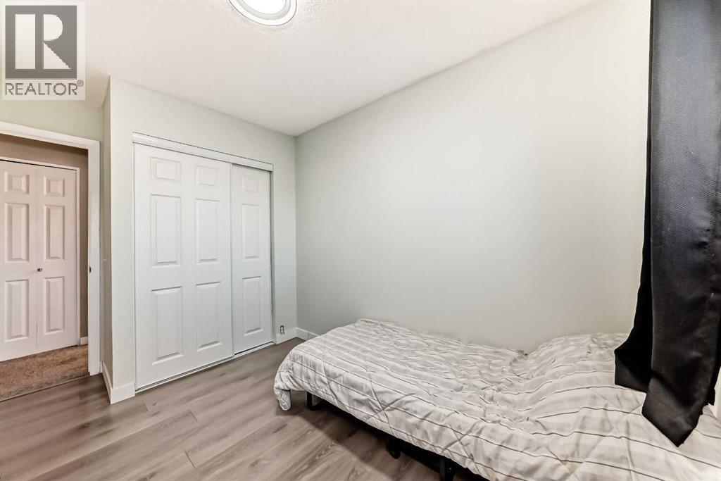 Secondary bedroom, with brand new closet doors (2026) - 7840 20A Street Se, Calgary, AB - Indoor Photo Showing Bedroom