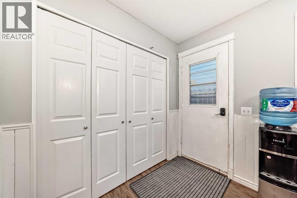 Back door leading to your fully landscaped yard - front & back! - 7840 20A Street Se, Calgary, AB - Indoor Photo Showing Other Room