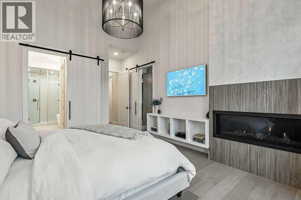56 Lissington Drive Sw, Calgary, AB - Indoor Photo Showing Bedroom With Fireplace