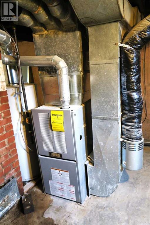 Newer Furnace. & NEW Hot Water Tank - 407 4 Avenue, Gleichen, AB - Indoor Photo Showing Basement