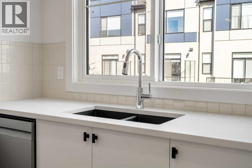 302, 550 Seton Circle Se, Calgary, AB - Indoor Photo Showing Kitchen With Double Sink