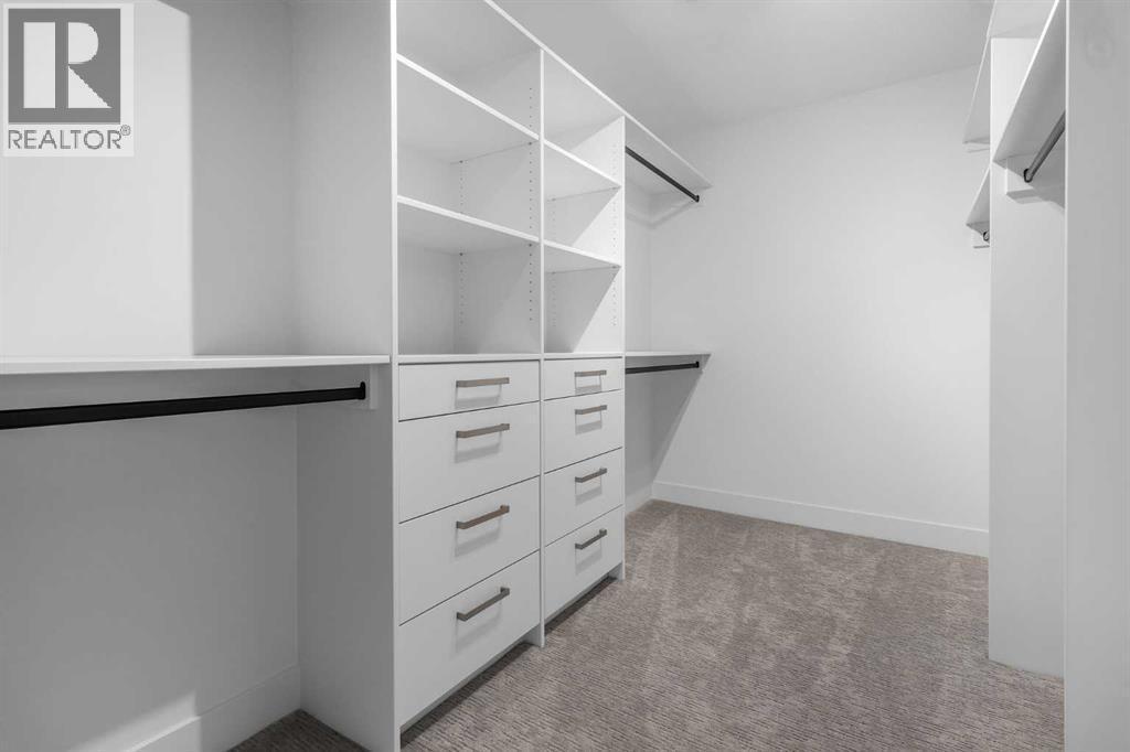 PRIMARY BEDROOM CLOSET - 340 West Chestermere Drive, Chestermere, AB - Indoor With Storage