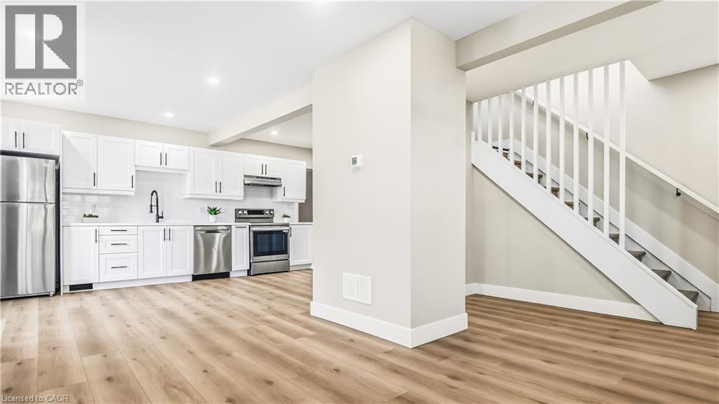 Kitchen with stainless steel appliances, light countertops, white cabinetry, light wood-style flooring, and recessed lighting - 491 Upper Wentworth Street, Hamilton, ON - Indoor Photo Showing Kitchen