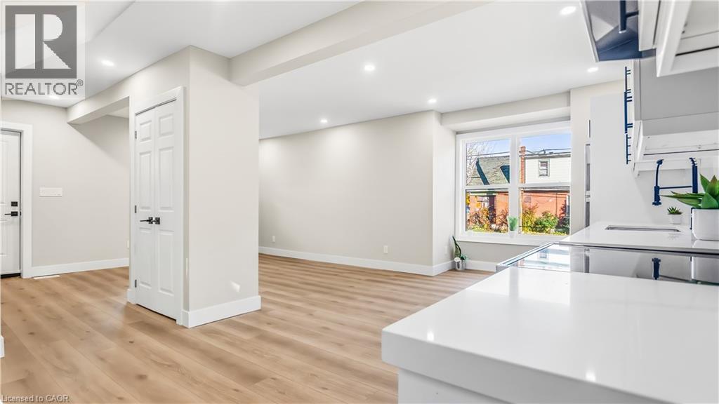 Kitchen with light wood finished floors, recessed lighting, and light stone counters - 491 Upper Wentworth Street, Hamilton, ON - Indoor