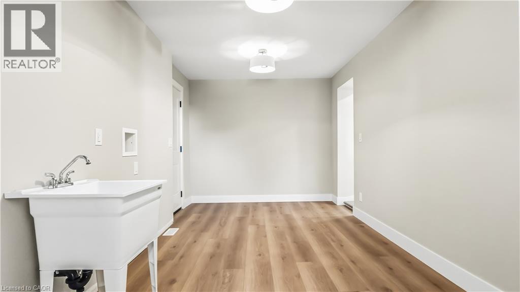 Laundry room with hookup for a washing machine and light wood-style flooring - 491 Upper Wentworth Street, Hamilton, ON - Indoor Photo Showing Other Room
