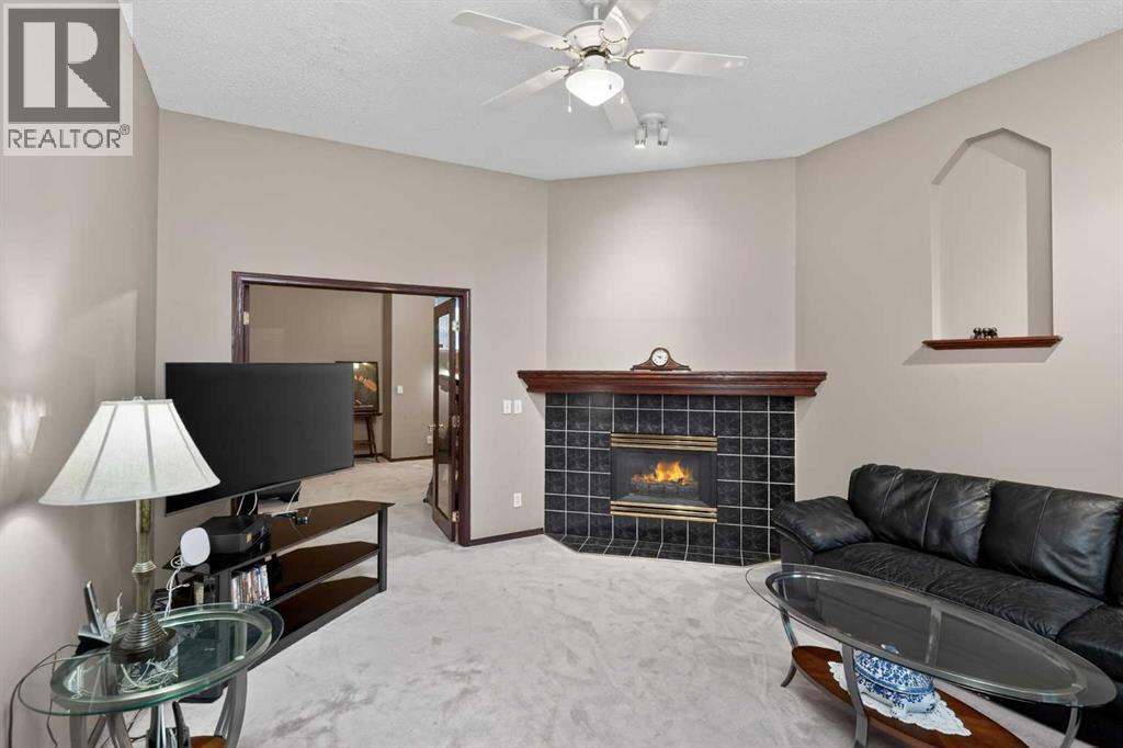 150 Somerset Close Sw, Calgary, AB - Indoor Photo Showing Living Room With Fireplace