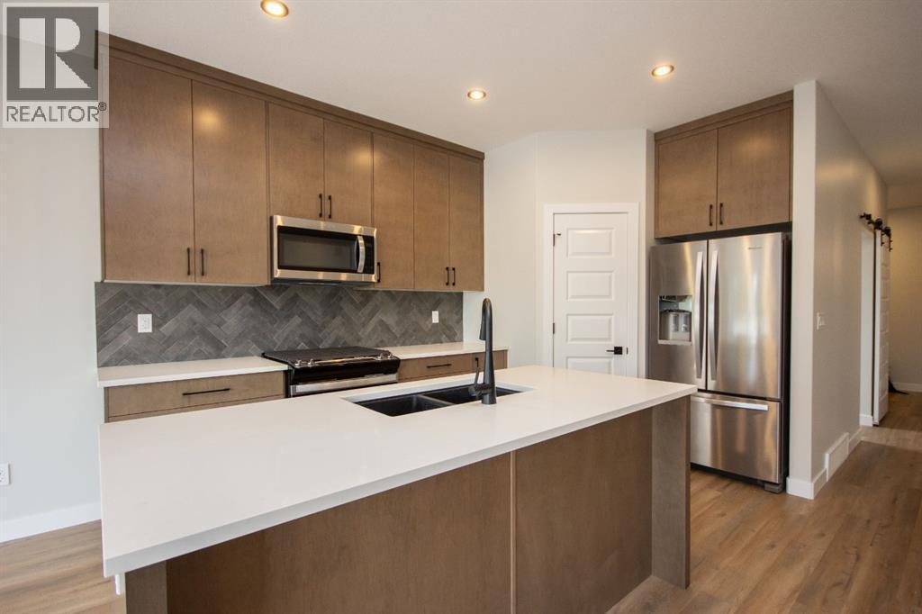 Photos and renderings are examples from a similar home built previously and do not necessarily reflect finished and colours used in this home - 37 Terra Close, Red Deer, AB - Indoor Photo Showing Kitchen With Stainless Steel Kitchen With Double Sink