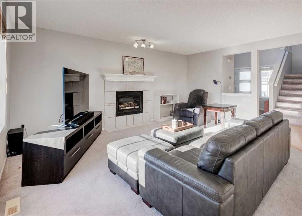 239 Chapalina Place Se, Calgary, AB - Indoor Photo Showing Living Room With Fireplace