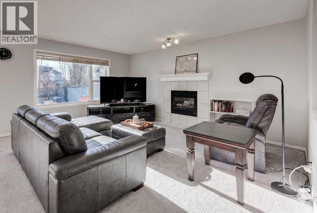 239 Chapalina Place Se, Calgary, AB - Indoor Photo Showing Living Room With Fireplace