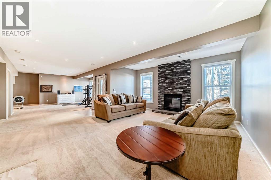 49 Crestridge View Sw, Calgary, AB - Indoor Photo Showing Other Room With Fireplace