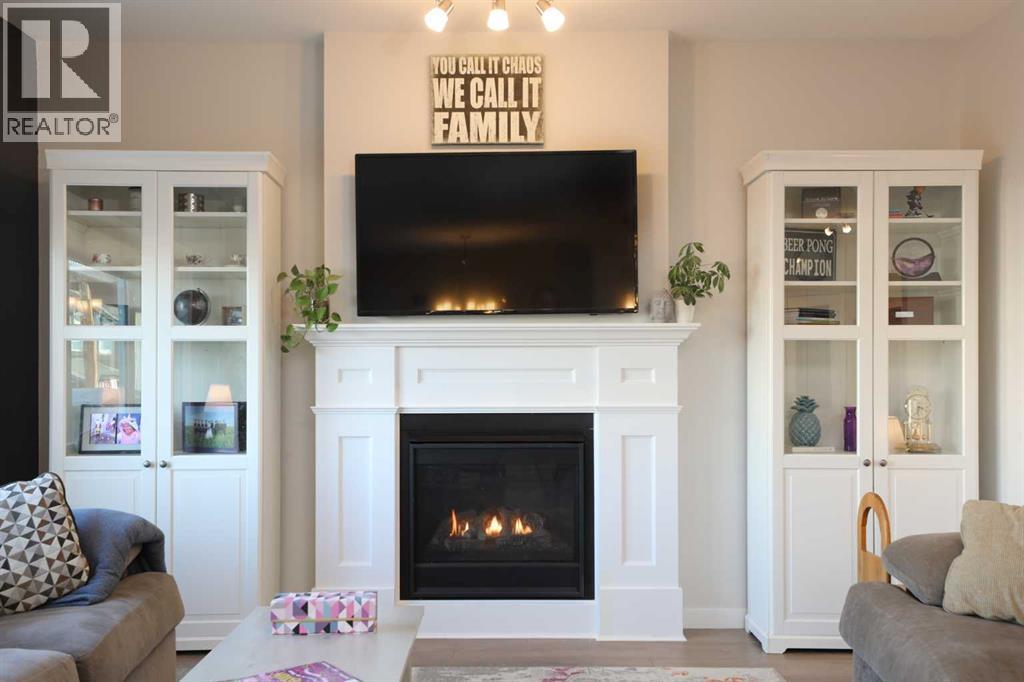 711 Moonlight Crescent W, Lethbridge, AB - Indoor Photo Showing Living Room With Fireplace