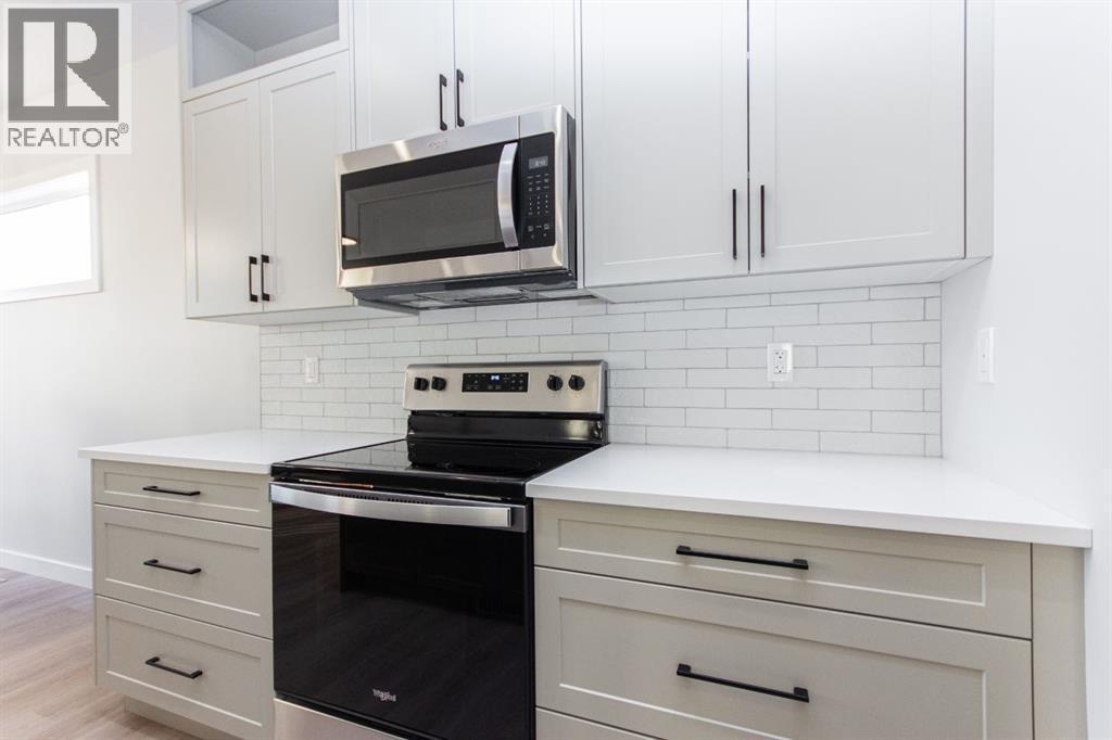 Photos and renderings are examples from a similar home built previously and do not necessarily reflect finished and colours used in this home - 41 Terra Close, Red Deer, AB - Indoor Photo Showing Kitchen