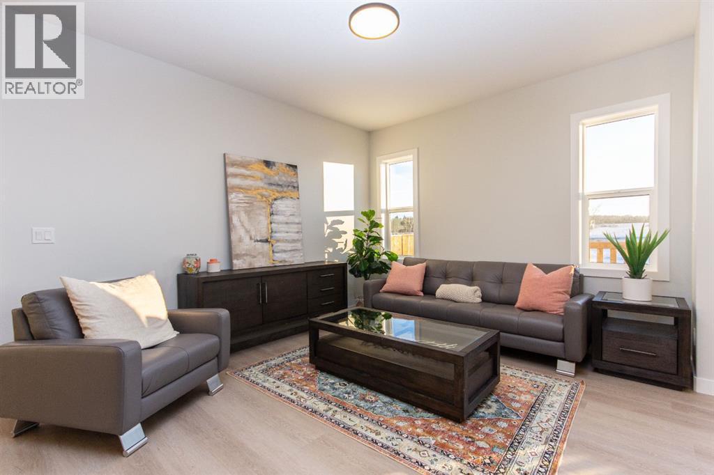 Photos and renderings are examples from a similar home built previously and do not necessarily reflect finished and colours used in this home - 41 Terra Close, Red Deer, AB - Indoor Photo Showing Living Room