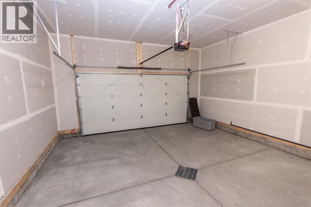 Photos and renderings are examples from a similar home built previously and do not necessarily reflect finished and colours used in this home - 41 Terra Close, Red Deer, AB - Indoor Photo Showing Garage