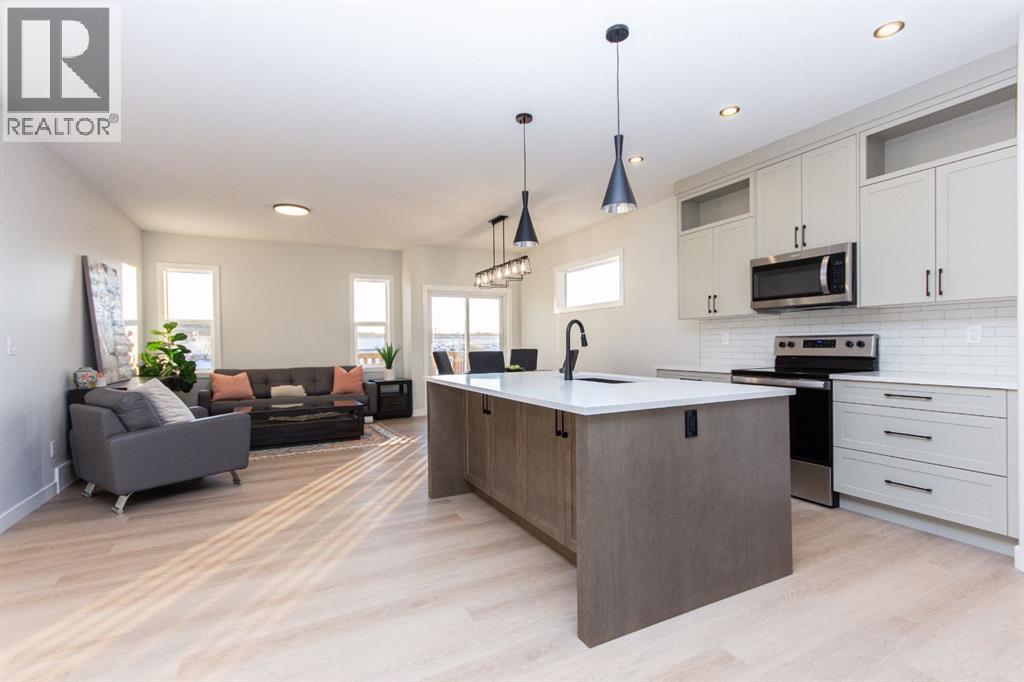 Photos and renderings are examples from a similar home built previously and do not necessarily reflect finished and colours used in this home - 41 Terra Close, Red Deer, AB - Indoor Photo Showing Kitchen With Upgraded Kitchen