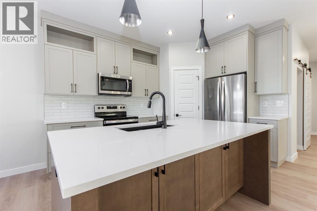 Photos and renderings are examples from a similar home built previously and do not necessarily reflect finished and colours used in this home - 41 Terra Close, Red Deer, AB - Indoor Photo Showing Kitchen With Stainless Steel Kitchen With Upgraded Kitchen