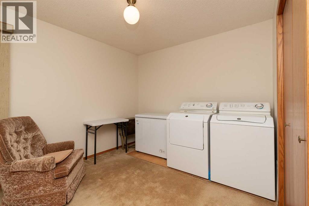 3rd bedroom upstairs currently used for laundry - 83 Elm Crescent S, Lethbridge, AB - Indoor Photo Showing Laundry Room