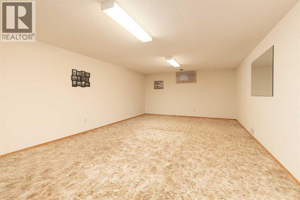 Large games room area - 83 Elm Crescent S, Lethbridge, AB - Indoor Photo Showing Other Room