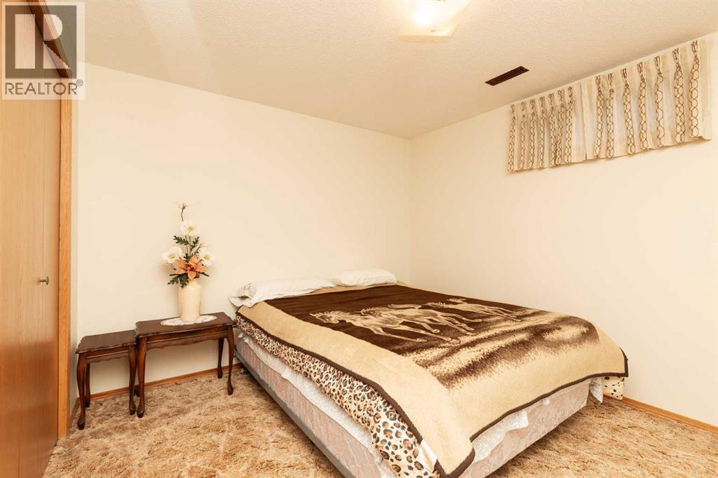 4th bedroom downstairs - 83 Elm Crescent S, Lethbridge, AB - Indoor Photo Showing Bedroom