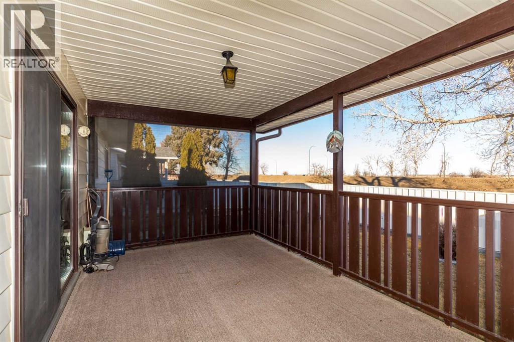 Covered back patio - 83 Elm Crescent S, Lethbridge, AB - Outdoor With Deck Patio Veranda With Exterior