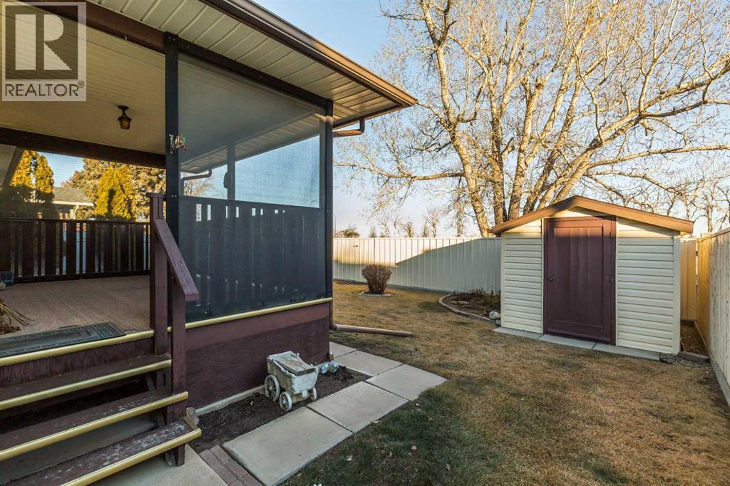 Fenced back yad - 83 Elm Crescent S, Lethbridge, AB - Outdoor With Deck Patio Veranda With Exterior