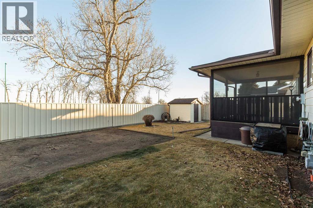 Fenced back yard - 83 Elm Crescent S, Lethbridge, AB - Outdoor With Deck Patio Veranda