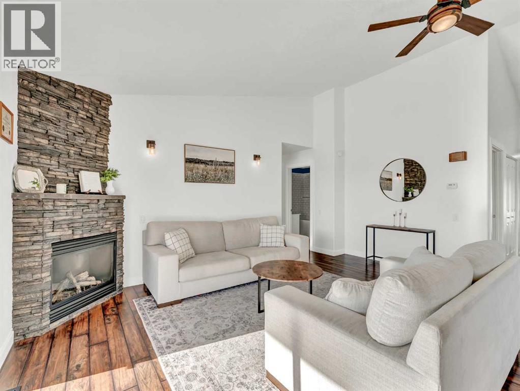 122 Redcliff Way Sw, Redcliff, AB - Indoor Photo Showing Living Room With Fireplace
