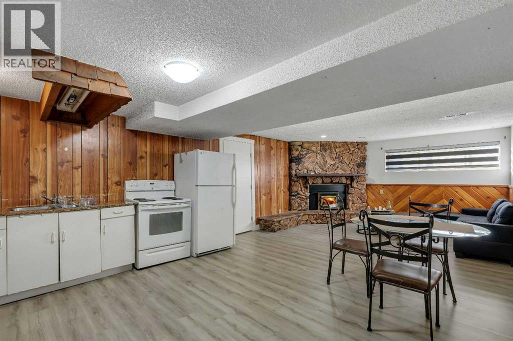 108 Whiteglen Crescent Ne, Calgary, AB - Indoor Photo Showing Kitchen With Fireplace With Double Sink