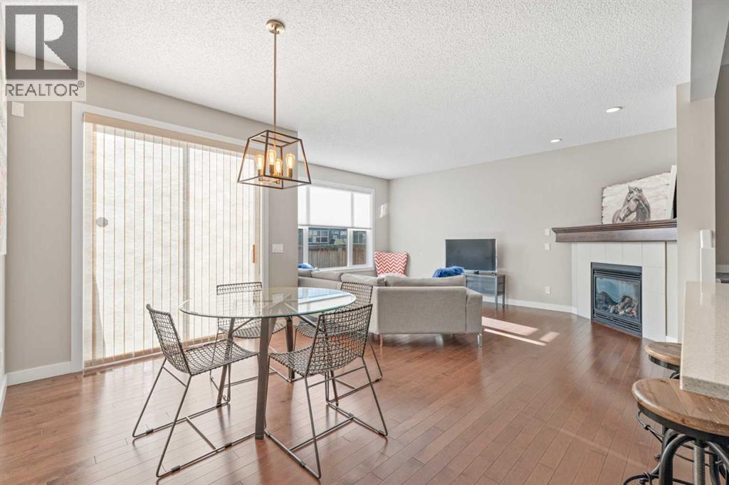 Leading to the back yard - 308 Chaparral Valley Way Se, Calgary, AB - Indoor Photo Showing Dining Room With Fireplace