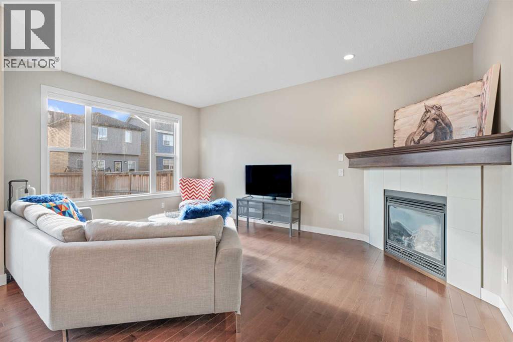 Bright living room - 308 Chaparral Valley Way Se, Calgary, AB - Indoor Photo Showing Living Room With Fireplace